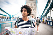istock solo traveler in tower bridge area reading a map 600990082