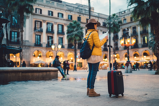 Solo traveler with map at Placa Reial,Barcelona
