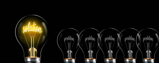 solution concept and prolem. solution word glows in bulb, problem is uninspiring stock photo