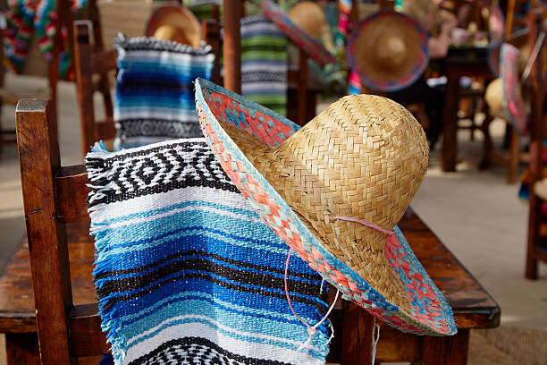 Sombrero And Mexican Blanket Hang Over Chair Back stock photo
