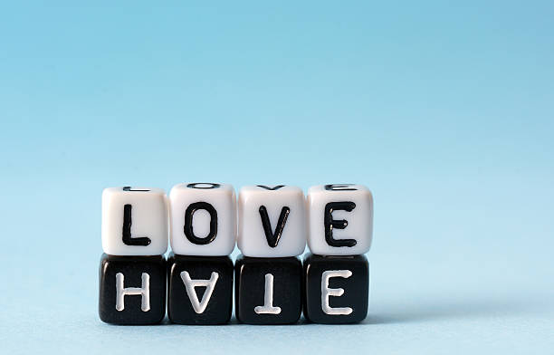 Some Boggle cubes spelling out the words love and hate stock photo