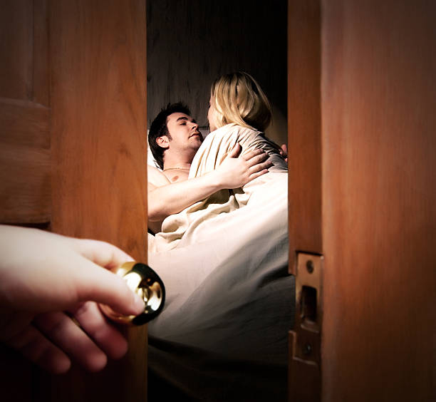 Someone opening a door and spying on man and young girl stock photo
