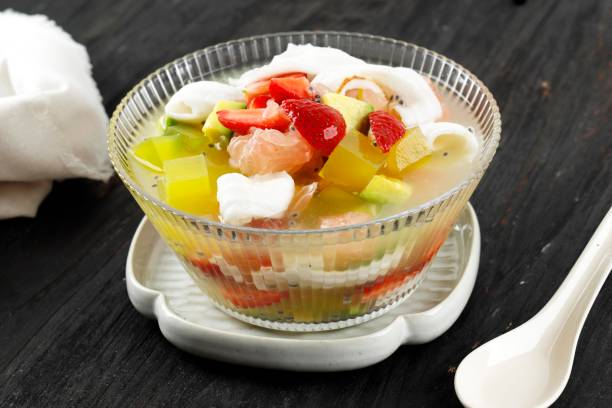 Sop Buah or Es Buah is Mixed Fruit with Coconut or Simple Syrup, Served with Shaved Ice and add Condensed Milk to Add Creamy Swetened stock photo