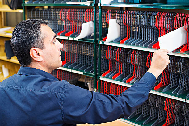 Sorting mail Postman sorting mail in the Mailroom post structure stock pictures, royalty-free photos & images
