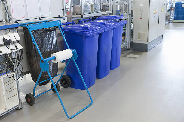 Sorting of waste into the bins in the assembly factory stock photo