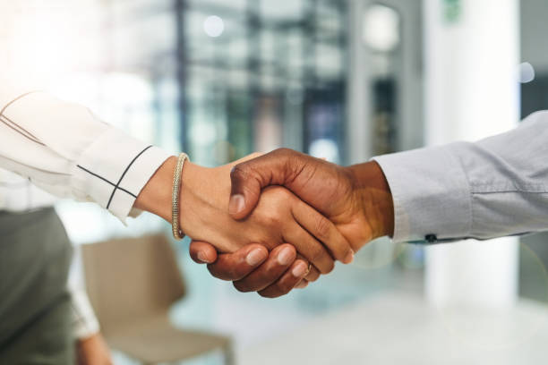 Sounds like a perfect deal to me Closeup shot of two businesspeople shaking hands in an office handshake stock pictures, royalty-free photos & images