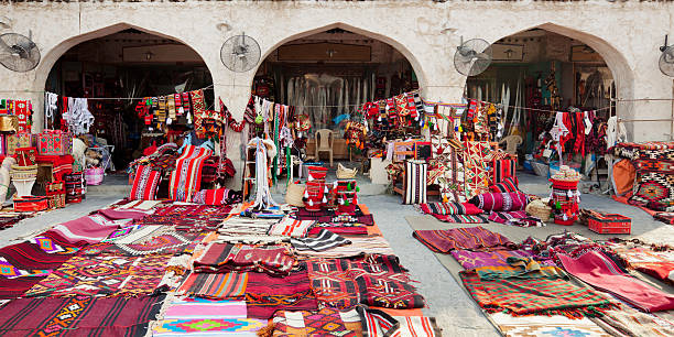 Souq Waqif shop "Textile shop along the street in the Souq Waqif area in Doha, Qatar." souk stock pictures, royalty-free photos & images