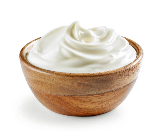 sour cream or yogurt in wooden bowl stock photo