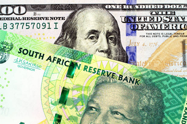A South African Ten Rand Bank Note With An American One Hundred Dollar Bill stock photo