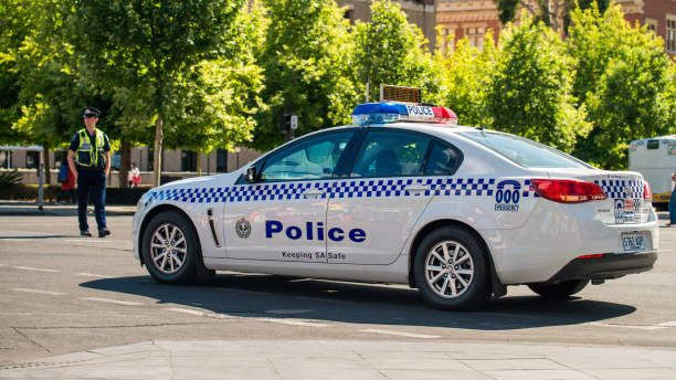 South Australian police car Adelaide: South Australian police car closed the street in  Adelaide's CBD with the policeman patrolling on the background south australia stock pictures, royalty-free photos & images