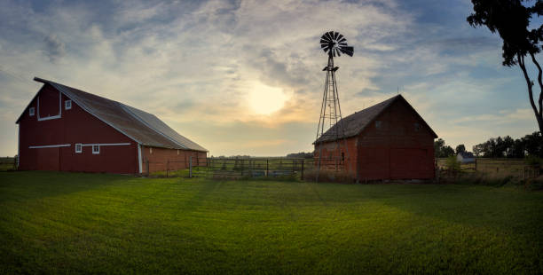 South Dakota Barnyard with Windmill A barnyard with windmill set on the South Dakota plains at Sunset. agricultural building stock pictures, royalty-free photos & images