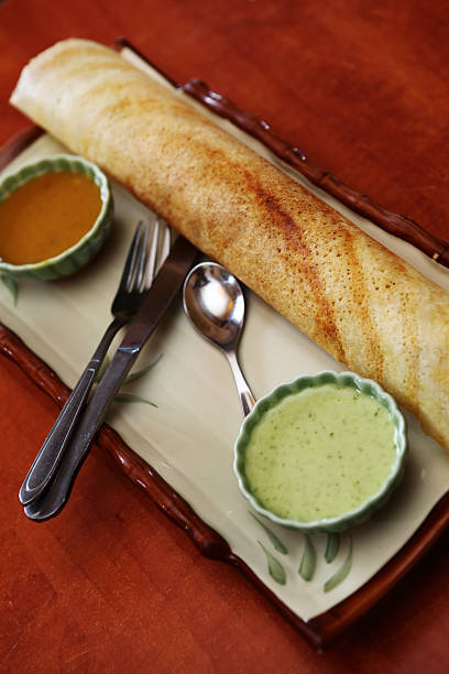 South Indian crepe Masala Dosa "The dosa (Dosay, Dose, Dosai, Dhosha, Thosai, Tosai,Chakuli) is a fermented crepe or pancake made from riceflour and black lentils. It is a typical dish in South Indian cuisine, eaten for breakfast or dinner, and is rich in carbohydrates and protein.Masala Dosa famous south Indian vegetarian snacks." thosai stock pictures, royalty-free photos & images