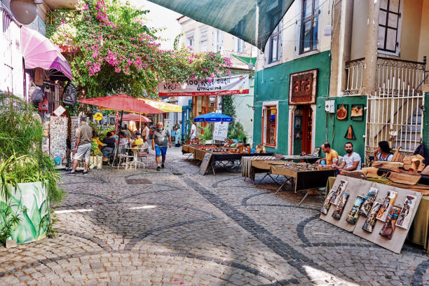Souvenir shops, cafes and people in Urla art street (sanat sokagi) in İzmir, Turkey. stock photo