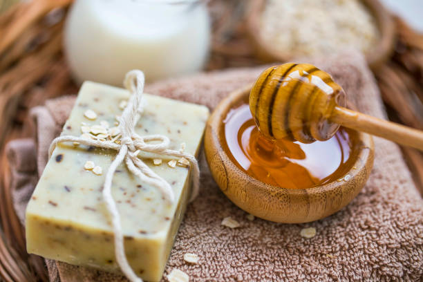 Spa still life with natural honey and oats soap, home spa setting with organic natural treatments stock photo