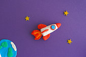 Space Rocket Blasting Off For New Ideas. Earth, space rocket and stars are made out of play clay (plasticine).