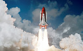 istock Space shuttle rocket launch in the sky and clouds to outer space. Sky and clouds. Spacecraft flight. Elements of this image furnished by NASA 1344443930