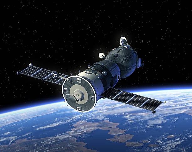 A spacecraft known as a satellite that's orbiting the earth  Spacecraft Orbiting Earth. 3D Scene. Elements of this image furnished by NASA.  soyuz space mission stock pictures, royalty-free photos & images