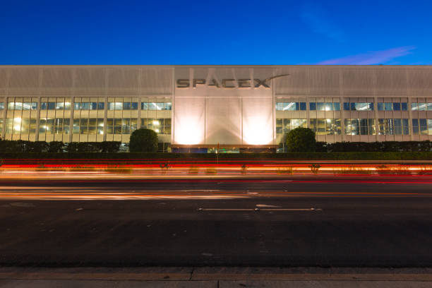 SpaceX Headquarters in Hawthorne California as a long exposure shot Hawthorne CA USA: August 24 2018: SpaceX designs, manufactures and launches advanced rockets and spacecraft. The company was founded in 2002 to revolutionize space technology, with the ultimate goal of enabling people to live on other planets. Falcon 9 is a two-stage rocket designed and manufactured by SpaceX for the reliable and safe transport of satellites and the Dragon spacecraft into orbit. Falcon 9 is the first orbital class rocket capable of reflight. SpaceX believes rocket reusability is the key breakthrough needed to reduce the cost of access to space and enable people to live on other planets. Falcon 9 was designed from the ground up for maximum reliability. Falcon 9’s simple two-stage configuration minimizes the number of separation events -- and with nine first-stage engines, it can safely complete its mission even in the event of an engine shutdown. iridium stock pictures, royalty-free photos & images