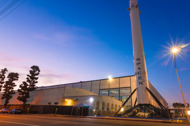 SpaceX Headquarters in Hawthorne California as a long exposure shot Hawthorne CA USA: August 24 2018: SpaceX designs, manufactures and launches advanced rockets and spacecraft. The company was founded in 2002 to revolutionize space technology, with the ultimate goal of enabling people to live on other planets. Falcon 9 is a two-stage rocket designed and manufactured by SpaceX for the reliable and safe transport of satellites and the Dragon spacecraft into orbit. Falcon 9 is the first orbital class rocket capable of reflight. SpaceX believes rocket reusability is the key breakthrough needed to reduce the cost of access to space and enable people to live on other planets. Falcon 9 was designed from the ground up for maximum reliability. Falcon 9’s simple two-stage configuration minimizes the number of separation events -- and with nine first-stage engines, it can safely complete its mission even in the event of an engine shutdown. iridium stock pictures, royalty-free photos & images