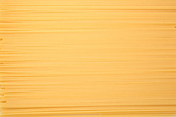 Spaghetti Pasta Textured Background Spaghetti forming a textured background with a striped pattern uncooked pasta stock pictures, royalty-free photos & images