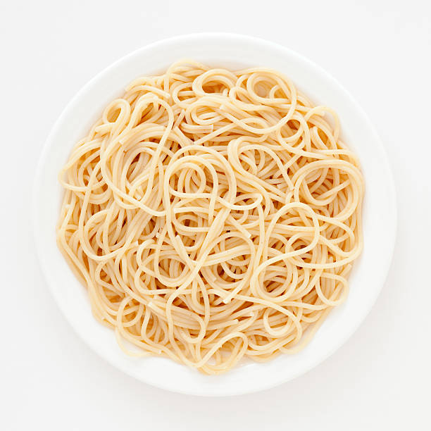 Spaghetti Top view of white dish with boiled spaghetti over it spaghetti stock pictures, royalty-free photos & images
