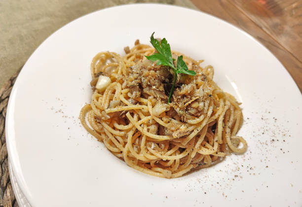 spaghetti with fresh anchovies stock photo