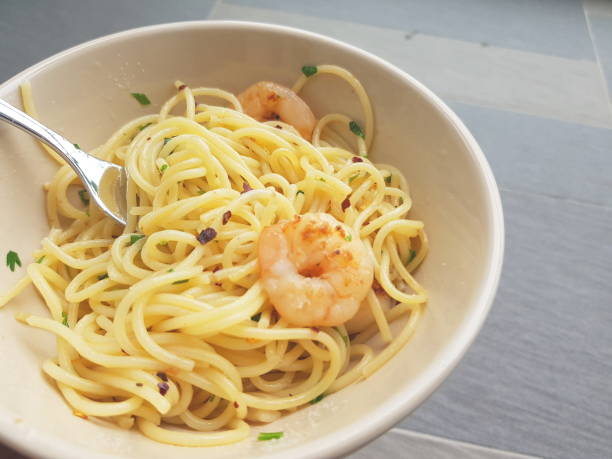 Spaghetti with prawns and herbs stock photo