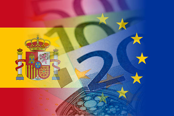 spain and eu flags with euro banknotes stock photo