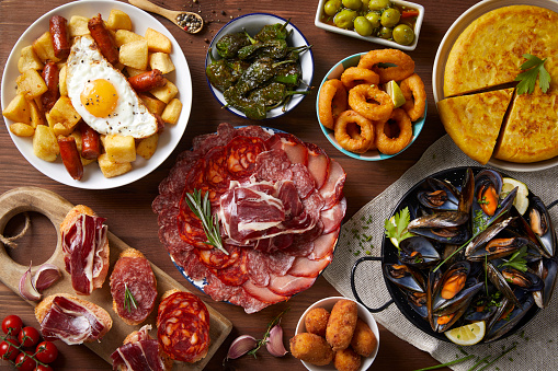 A table with typical Spanish food seen from above on a wooden table