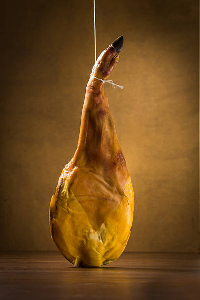 Spanish iberian ham Spanish iberian ham isolated on wood background animal leg stock pictures, royalty-free photos & images