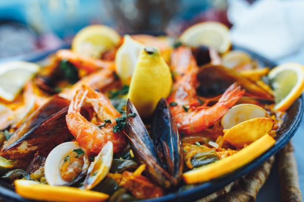 spanish seafood paella, closeup view spanish seafood paella, closeup view comunidad autonoma de valencia stock pictures, royalty-free photos & images