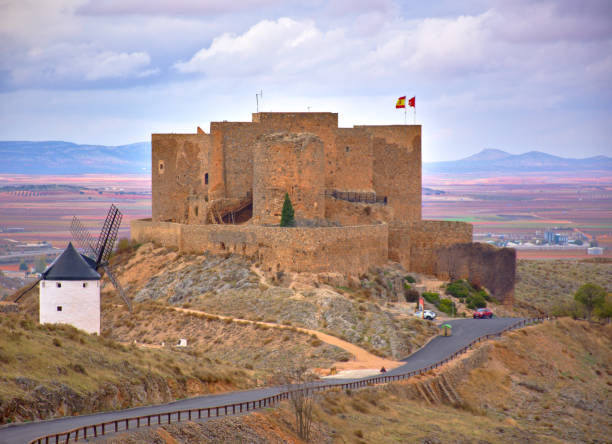 Spanish windmills and castle at a cloudy day stock photo