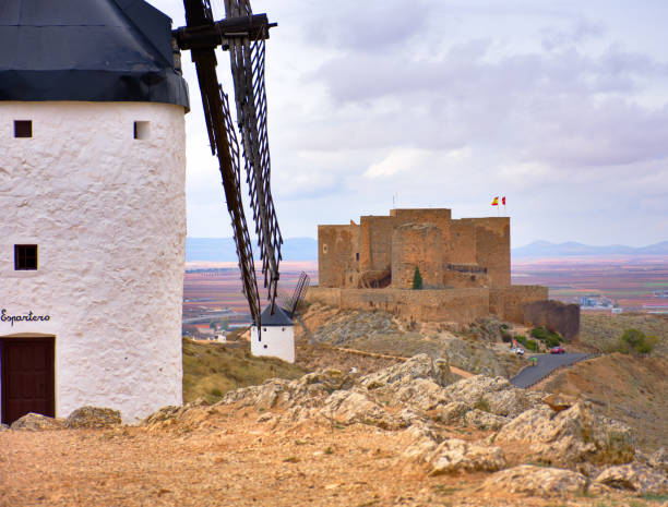 Spanish windmills and castle at a cloudy day stock photo