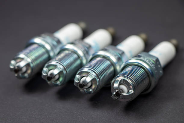 Spark plugs on black background. Car and motorcycle part Spark plugs on black background. Car and motorcycle part. iridium stock pictures, royalty-free photos & images