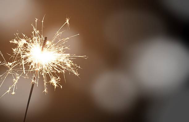 sparkler - New Year's Eve sparkler - celebrating New Year's Eve sparkler firework stock pictures, royalty-free photos & images
