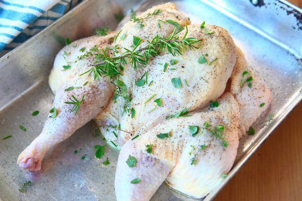 Spatchcock chicken with fresh herbs stock photo