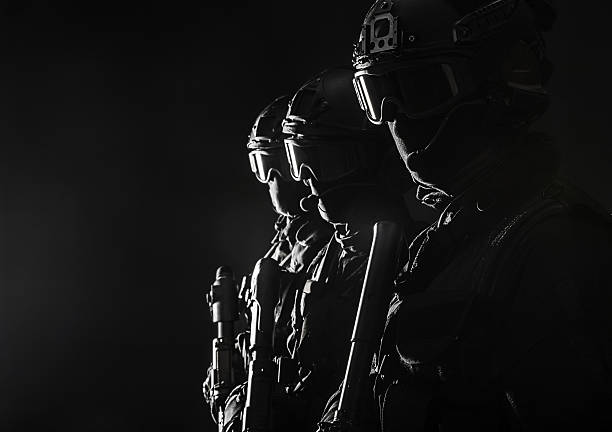 Spec ops police officersSWAT Spec ops police officers SWAT in black uniform and face mask studio shot special forces stock pictures, royalty-free photos & images