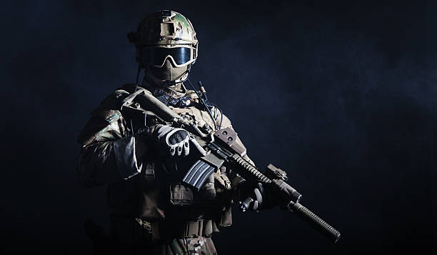 Special forces soldier Special forces soldier with rifle on dark background special forces stock pictures, royalty-free photos & images