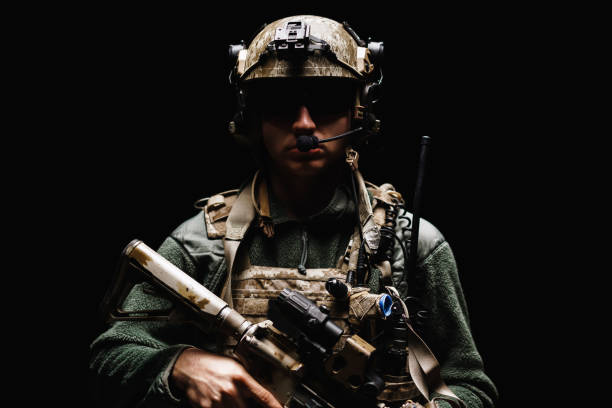 Special forces soldier with rifle on black background stock photo