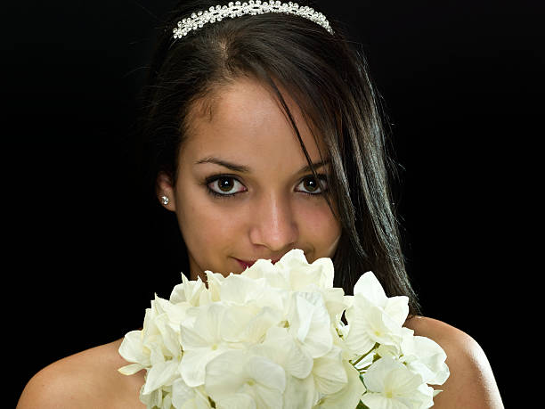 Special Night Hispanic teenage girl  holding a white flowers bouquet on black background  (this picture has been shot with a super high definition Hasselblad HD3 II 31 megapixels camera) cute puerto rican girls stock pictures, royalty-free photos & images