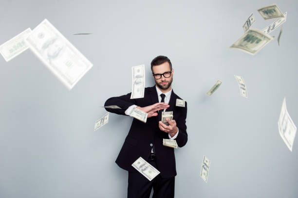 Spectacles jackpot entrepreneur economist banker chic posh manager jacket concept. Handsome confident cunning clever wealthy rich luxury guy holding wasting stack of money isolated on gray background  throwing stock pictures, royalty-free photos & images