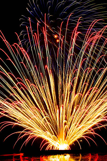 spectacular fireworks display in dark sky stock photo