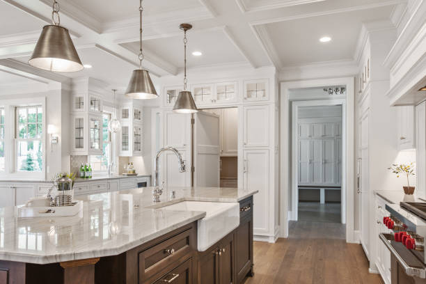 Spectacular kitchen in brand new tour home White kitchen with brown island and coffered ceiling farmhouse stock pictures, royalty-free photos & images
