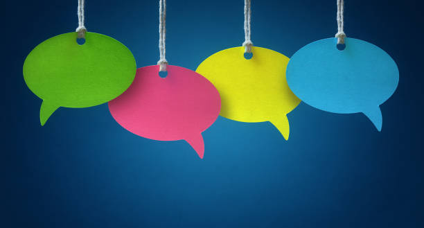 Speech bubbles Blank colorful speech bubbles hanging from a cord over blue background single word stock pictures, royalty-free photos & images
