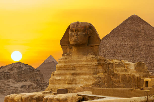 Sphinx against the backdrop of the great Egyptian pyramids. Africa, Giza Plateau.  sphinx stock pictures, royalty-free photos & images