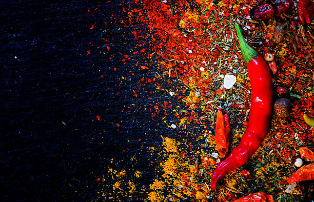 Spices and spicy chili peppers Spices and spicy chili peppers, top view indian food stock pictures, royalty-free photos & images