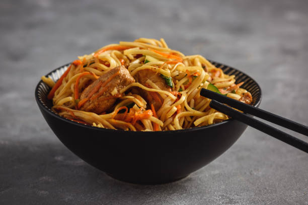 Spicy asian noodles with chicken and vegetables. stock photo