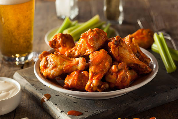 Spicy Homemade Buffalo Wings Spicy Homemade Buffalo Wings with Dip and Beer crunchy stock pictures, royalty-free photos & images