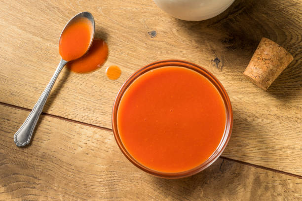 Spicy Hot Organic Red Buffalo Sauce Spicy Hot Organic Red Buffalo Sauce in a Bowl sauce stock pictures, royalty-free photos & images
