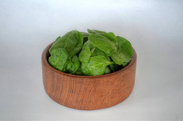 Spinach in Natural Wood Bowl stock photo